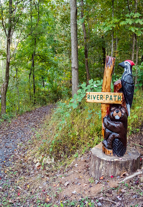 Hiking path sign: a wooden carved beaver and birth totem, Hikes, Fishtrap Village Rental Cabins